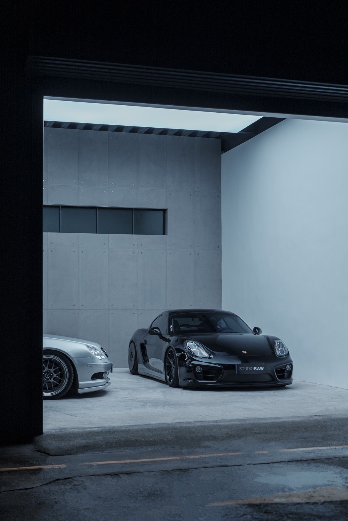 Black Porsche framed by the garage entrance