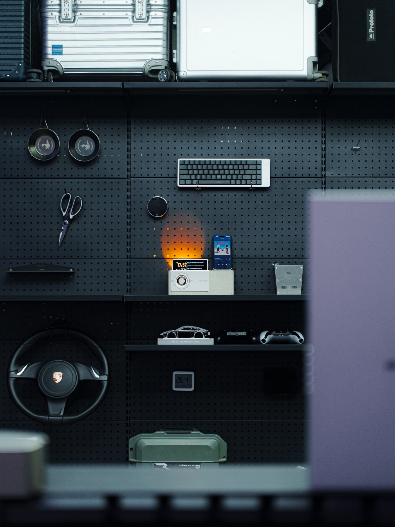 Black tool wall with studio objects and devices