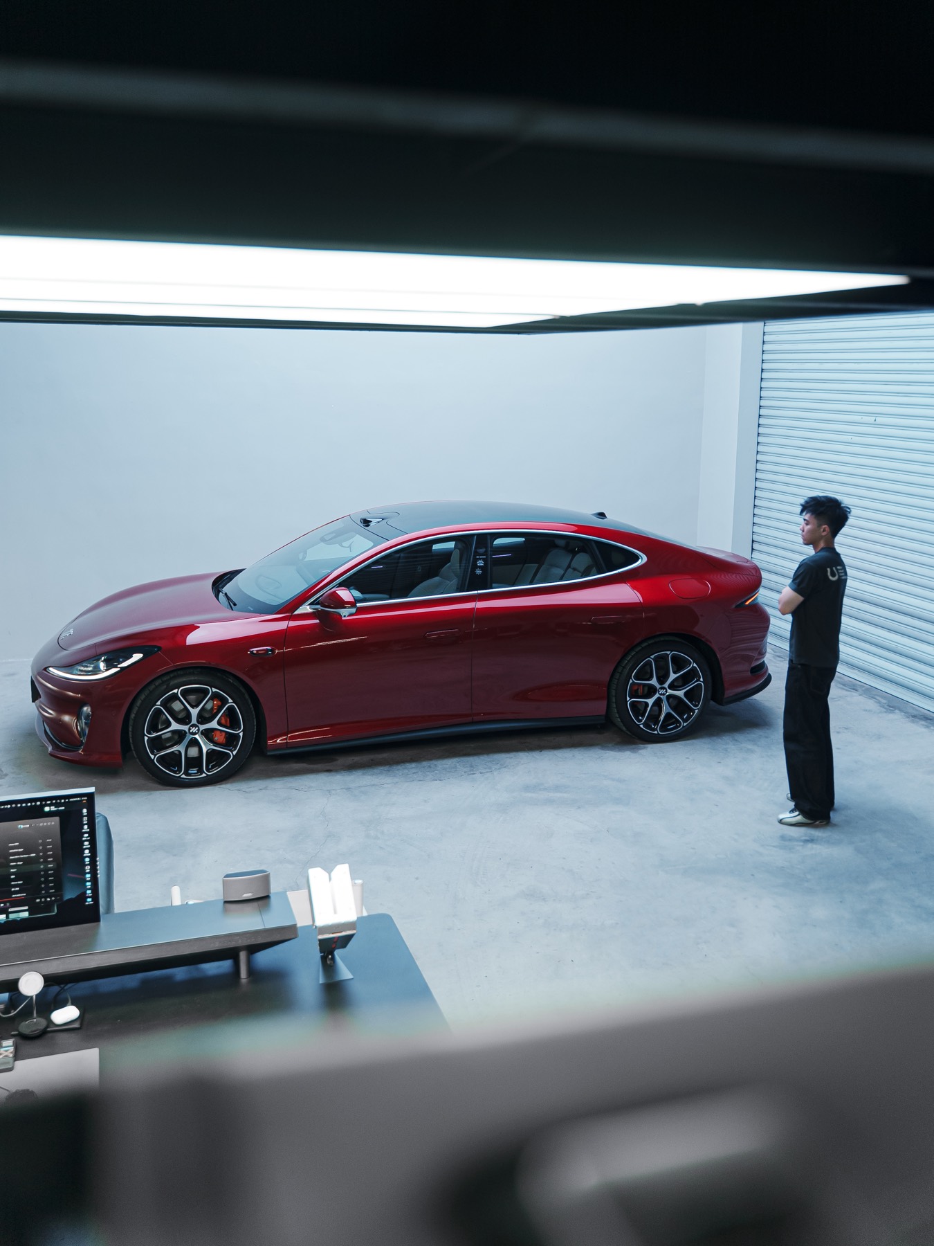 Red sedan staged inside the garage studio